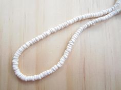 "White puka shell necklace with silver plated screw clasp or lobster clasp in 4 sizes to choose from 14\", 16\", 18\", 20\" . Bright white rounded polished puka beads that measure approximately 1/4\". Now available white puka bracelet (7\") and anklet (10\"). Great addition to your jewelry collection, great gift idea or use it in crafts. Puka shells are gifted to wish good luck to the receiver." White Strand Necklace With Lobster Clasp, White Adjustable Beaded Necklace With Lobster Clasp, Adjustable White Beaded Necklace With Lobster Clasp, White Beaded Necklace With Lobster Clasp For Beach, White Single Strand Necklace For Beach, White Shell Necklaces With Lobster Clasp, Adjustable Round Shell Necklace For Beach, Adjustable Round Shell Necklace For The Beach, White Round Beads Shell Necklace For Beach