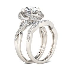 In a stunning display of style and craftsmanship, this luminous ring set is a luxurious ode to femininity. Glittering in bold brilliance, a shimmering round cut center stone is wrapped in a twist halo frame to create a floral look. Shimmering side stones glisten along the ring's twisted shank. On your wedding day, complete this exquisite ensemble by adding the coordinating wedding band. This sure-to-be-cherished ring is certain to forge a lasting memory in your heart.Carat Weight: 2.5 ctStone Si Elegant Bridal Sets With Halo Setting For Promise, Elegant Bridal Sets With Halo Setting, Elegant Halo Ring With Moissanite Round Stone, Elegant Moissanite Halo Ring With Round Stone, Elegant Bridal Sets With Halo Setting For Formal Occasions, Elegant Formal Bridal Sets With Halo Setting, Elegant Rings With Halo And Round Stone, Elegant Diamond White Round Cut Bridal Sets, Elegant Bridal Sets With Diamond Accents And Round Band