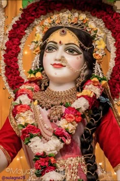 a statue of a woman with flowers in her hair and makeup on it's face