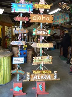 several wooden signs hanging from the ceiling in a store