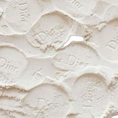 the texture of white paint is shown in this close up photo, with small circles and words on it