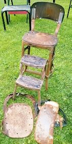 three old wooden chairs sitting on top of green grass next to each other in an open field