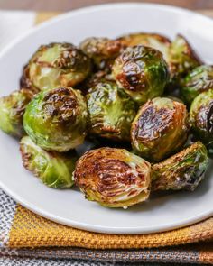 a white plate topped with brussel sprouts on top of a table