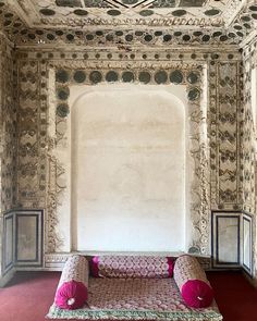 an ornate room with pink and white furniture