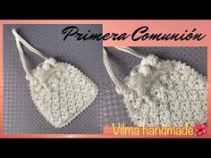 two crocheted hearts hanging from strings with the words prinera comunion written