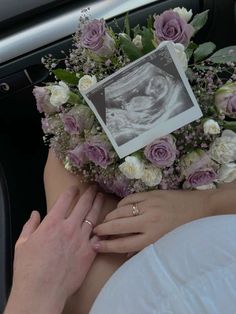 a woman is holding flowers in her lap