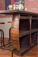 a wooden barrel sitting on top of a metal shelf next to a bar with stools