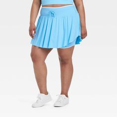 Why we're ALL IN: Solid-color seamless skort with soft gathers and wrap-style accents on the sides. Boasts a midweight nylon and spandex construction with four-way stretch as well as moisture-wicking properties to help keep you cool and comfy during any activity. The wide waistband with drawcord, built-in brief, mini length and mid-rise waist complete the sporty design. All in Motion™: Inspiring the potential in every body. Sporty Blue Swim Skirt With 4-way Stretch, Sporty Blue 4-way Stretch Swim Skirt, Solid Color Swim Skirt For Spring Sports, Spring Sports Swim Skirt In Solid Color, Blue Moisture-wicking Swim Skirt For Sports, Spring Sports Swim Skirt, Blue 4-way Stretch Sporty Skort, Blue Athleisure Swim Skirt For Sports, Sporty Stretch Blue Swim Skirt