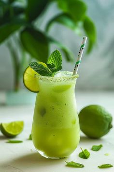 a green drink with lime and mint garnish