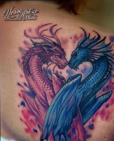 two colorful dragon tattoos on the back of a woman's shoulder and chest, with watercolor splashes all over it