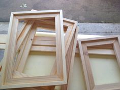 three wooden frames sitting next to each other