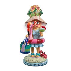 a statue of a girl with a flamingo holding a beach bag and wearing a hat