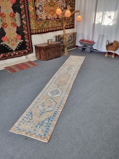 a long rug is on the floor in a room with other rugs and lamps