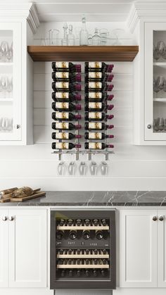 the wine rack is hanging on the wall above the kitchen counter and below it are several bottles of wine