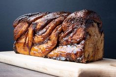 a loaf of bread sitting on top of a wooden cutting board