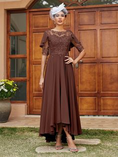 a woman standing in front of a wooden door wearing a brown dress and headpiece