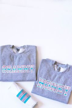 two t - shirts with the words granny and honey on them next to a tube of toothpaste