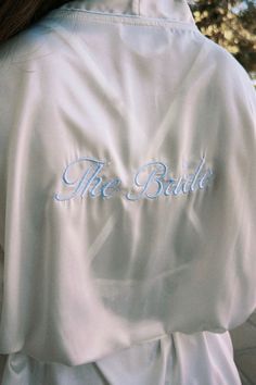 the back of a woman's white robe that says, the bride