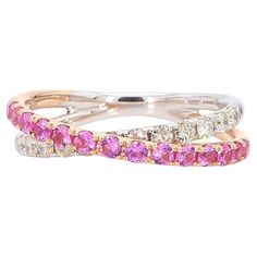 two rings with pink and white stones on each one, set in 18k gold