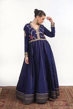 A royal blue frock in raw silk with embroidery on the bodice and a matching net dupatta with kiran along its width. Finished with a jamawar trouser for a regal touch.3-piece suitReady to wear Eid Dress With Intricate Embroidery In Raw Silk, Eid Raw Silk Dress With Intricate Embroidery, Raw Silk Dress With Zari Work For Navratri, Blue Floor-length Dupatta With Dabka, Elegant Chanderi Gown With Dori Work, Bollywood Style Dola Silk Festive Dress, Blue Jamawar Wedding Dress, Elegant Maxi Length Choli With Resham Embroidery, Eid Anarkali Jamawar Gown