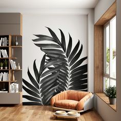 a living room with a palm leaf mural on the wall