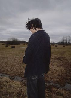 a man standing on top of a dry grass field