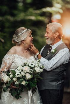 an older man and woman standing next to each other