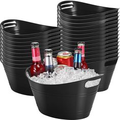 a set of six black ice buckets filled with soda and cola bottles next to each other