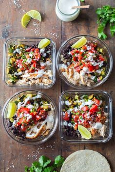 four plastic containers filled with chicken, black beans and veggies next to a tortilla