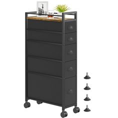 a tall black cabinet with wheels and a potted plant on top