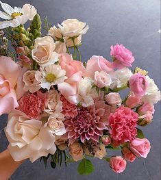 a person holding a bouquet of flowers in their hand