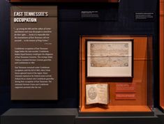 an old book is on display in a glass case with information about the earliest tennesses