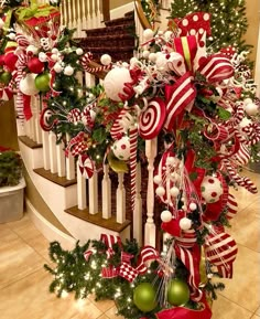 christmas decorations on the banisters and stairs are decorated with red, white and green ornaments