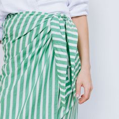 The sarong is the best accessory for your days at the pool or beach. And takes up zero room in your suitcase when you're packing for your beach vacation! Breezy, comfortable, and versatile our Green and White Stripe Vienna Sarong can be worn tied around the waist or even tied around the neck as a dress. Monogram Timeline: Please note the monogram process takes up to one week prior to shipment. Details and Care Measures 44" x 76"Very lightweight 100% cottonCare Instructions: Hand wash separate in Beachy Summer Swimwear For Travel, Beachy Swimwear For Summer Travel, Summer Cotton Beachwear Sarong, Summer Cotton Sarong For Beach, Summer Beachwear Cotton Sarong, Green Beachwear Sarong For Spring, Beachy Sarong For Summer Day Out, Beachy Summer Sarong For Day Out, Beachy Sarong For Beach Season Day Out