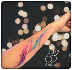 a woman's arm with the word faith written on it and an abstract background