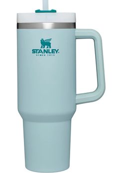 the stanley travel mug is light blue and has a stainless steel lid with an insulated handle