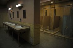 a public restroom with sinks and mirrors