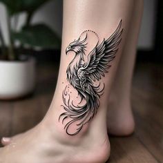 a woman's foot with a bird tattoo on it