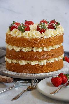 a cake with strawberries and icing sitting on a plate