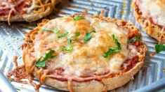 three mini pizzas sitting on top of a cooling rack