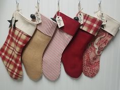 five christmas stockings hanging from hooks on a wall