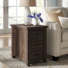 a living room scene with focus on the end table and vases sitting on it