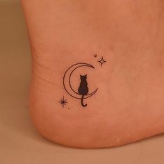 a black cat sitting on the moon tattoo