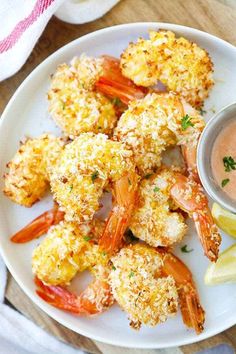 a white plate topped with fried shrimp and dipping sauce