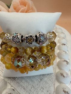 This is a beautiful eye catching four bracelet set in shades of yellow sunset with gorgeous Czech crystals, yellow tiger eye and citrine gemstones, and a focal with silver rhinestone slider beads.   This bracelet set is perfect for any occasion dressed up or down.  You will get many compliments when wearing it.  This is a great gift idea for any occasion for your wife, Mom or daughter.  We are a new Etsy shop and appreciate you shopping with us.   Please feel free to reach out with any questions. Thanks, Susan Yellow Stackable Beaded Bracelets, Bohemian Yellow Beaded Bracelets With Natural Stones, Elegant Yellow Beaded Bracelet With Faceted Beads, Yellow Faceted Beads Bracelet, Yellow Bohemian Beaded Bracelets With Gemstones, Elegant Yellow Beaded Crystal Bracelet, Adjustable Yellow Crystal Bracelet With Gemstone Beads, Adjustable Beaded Citrine Jewelry, Elegant Adjustable Yellow Crystal Bracelet