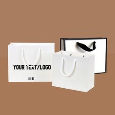 two white bags with black handles are next to each other on a brown background,