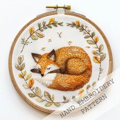 an embroidery kit with a fox sleeping on it's side and the words hand embrout diary written below