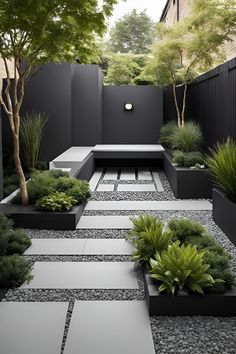 an outdoor garden with black and white stones, graveled walkways, trees and benches