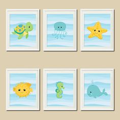 four framed pictures with sea animals on them, one in blue and the other in yellow