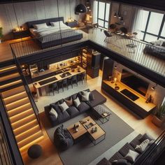 an aerial view of a living room and dining area in a loft style home with stairs leading up to the second floor